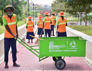 Smiling CleanTech Lanka cleaning crew standing proudly for a company showcase